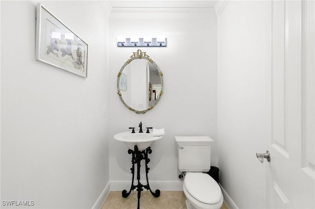 bathroom with tile patterned flooring, toilet, and ornamental molding