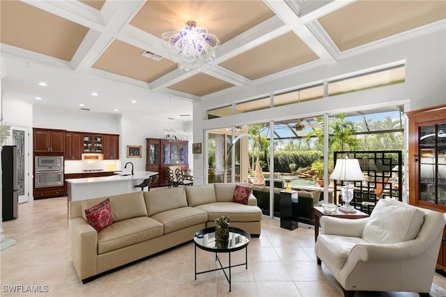 tiled living room featuring beam ceiling, ornamental molding, sink, and coffered ceiling