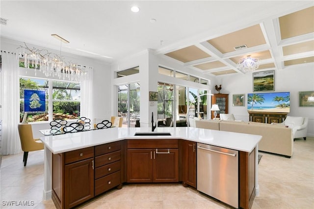 kitchen with a center island with sink, dishwasher, sink, and a chandelier