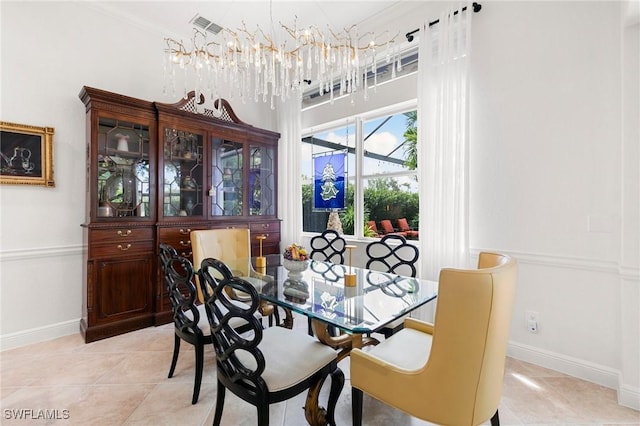 tiled dining room featuring crown molding and an inviting chandelier