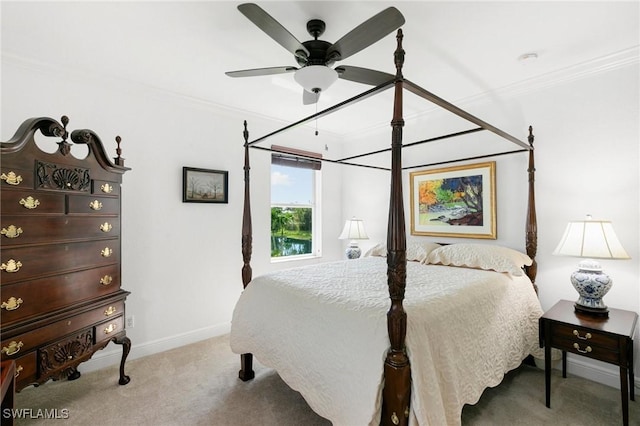 bedroom featuring ceiling fan, crown molding, and light carpet