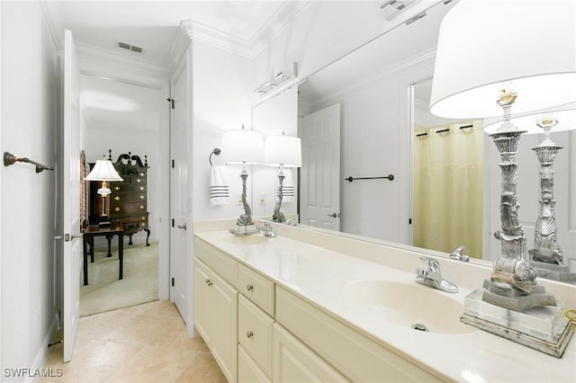 bathroom with crown molding, tile patterned flooring, and vanity