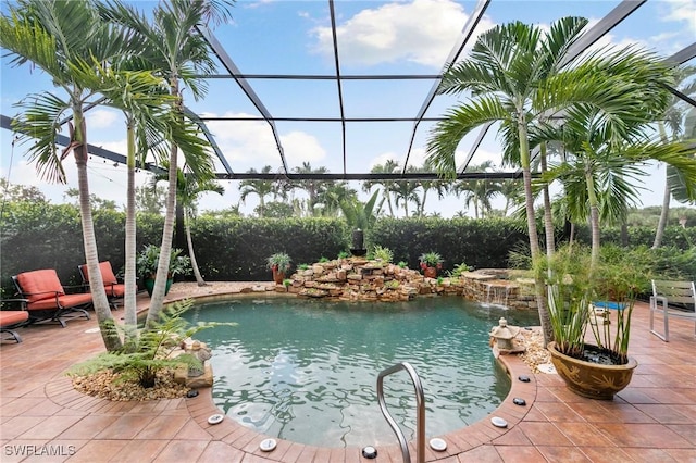 view of swimming pool with pool water feature and glass enclosure