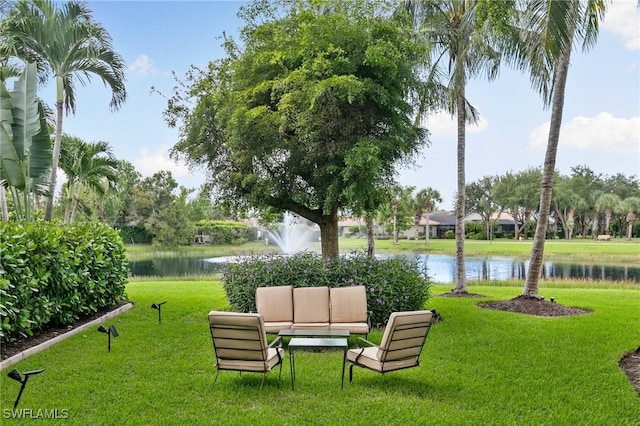 view of home's community featuring a yard and a water view