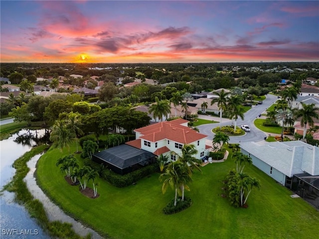 aerial view at dusk with a water view