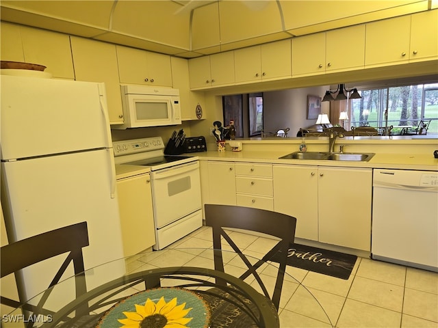 kitchen with light tile patterned floors, sink, and white appliances