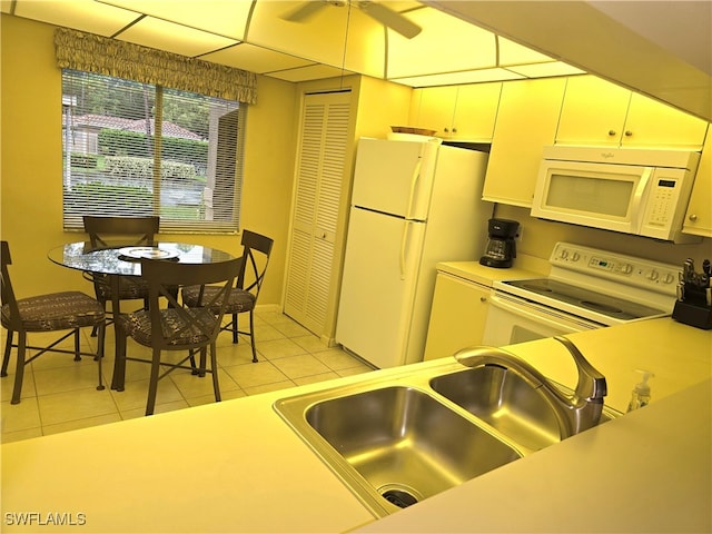 kitchen with sink, white appliances, ceiling fan, and light tile patterned floors