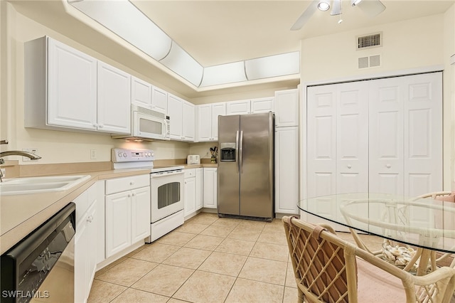 kitchen with ceiling fan, white cabinetry, light tile patterned floors, sink, and stainless steel appliances