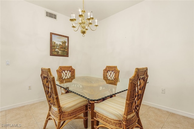 tiled dining room with a chandelier