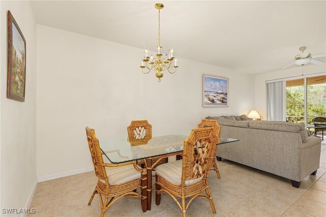 tiled dining area featuring ceiling fan with notable chandelier