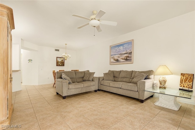 living room featuring ceiling fan with notable chandelier and light tile patterned floors