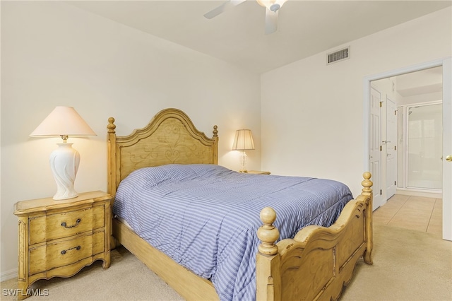 carpeted bedroom featuring ceiling fan and ensuite bath