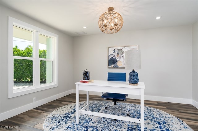 office area with an inviting chandelier and dark hardwood / wood-style flooring