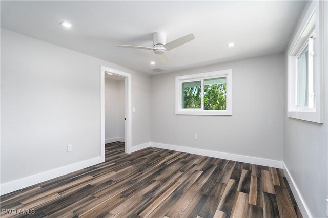 spare room featuring dark wood-type flooring and ceiling fan