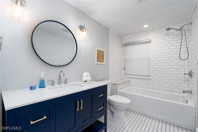 full bathroom with tile patterned flooring, tiled shower / bath, toilet, and vanity