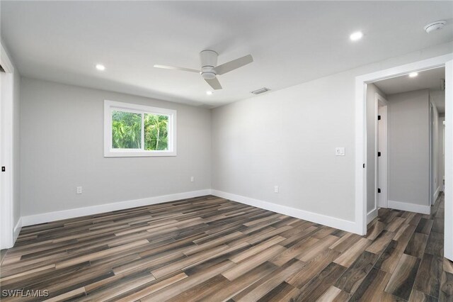 spare room featuring ceiling fan and dark hardwood / wood-style floors