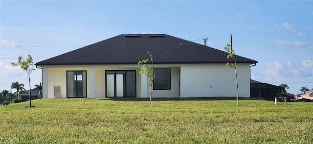 rear view of house with a yard