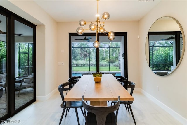 dining room featuring ceiling fan with notable chandelier