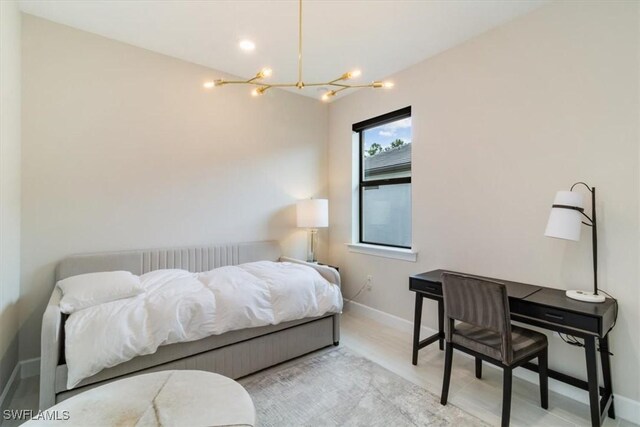 bedroom featuring a notable chandelier and light hardwood / wood-style floors