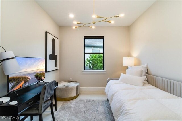 bedroom featuring a notable chandelier