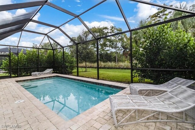 view of swimming pool with a patio area and glass enclosure