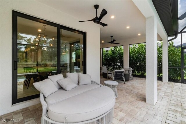 view of patio / terrace with ceiling fan and an outdoor living space