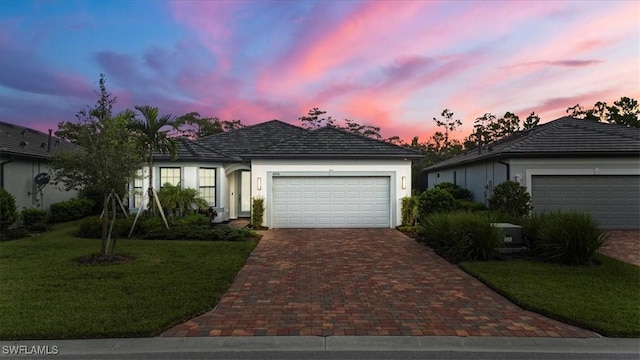 ranch-style home with a lawn and a garage