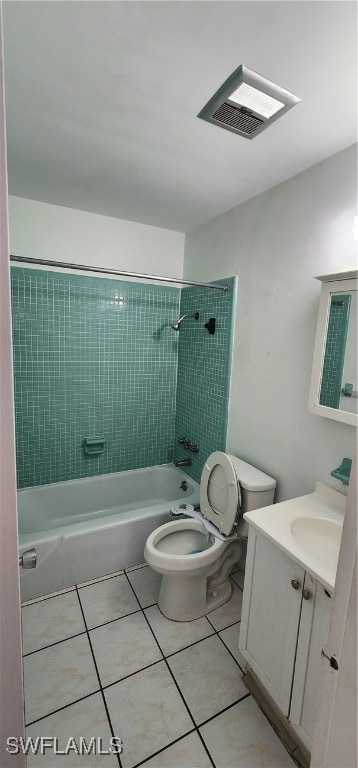 full bathroom with vanity, tiled shower / bath combo, toilet, and tile patterned floors