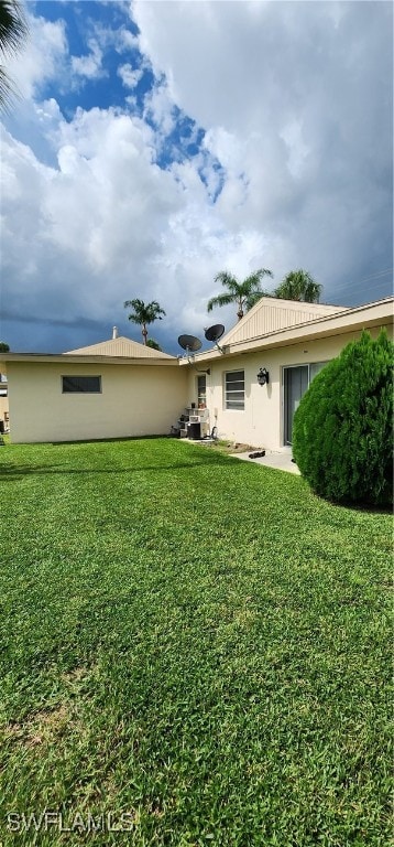 rear view of house with a yard