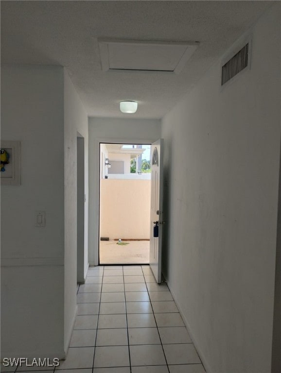 hall with light tile patterned floors