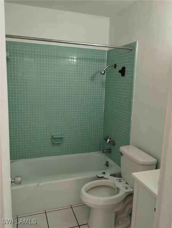 full bathroom with tiled shower / bath, vanity, toilet, and tile patterned floors