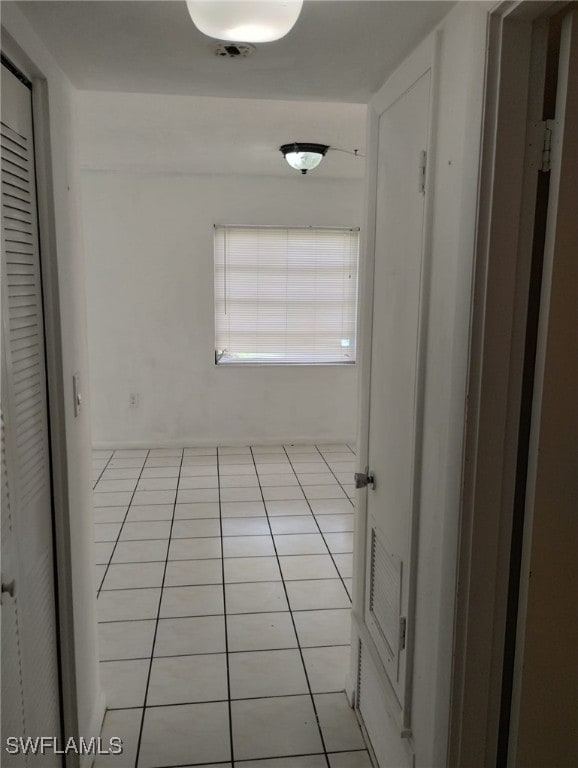 hall featuring light tile patterned floors