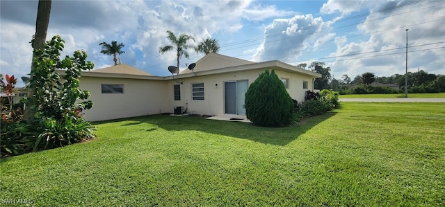 rear view of property featuring a yard