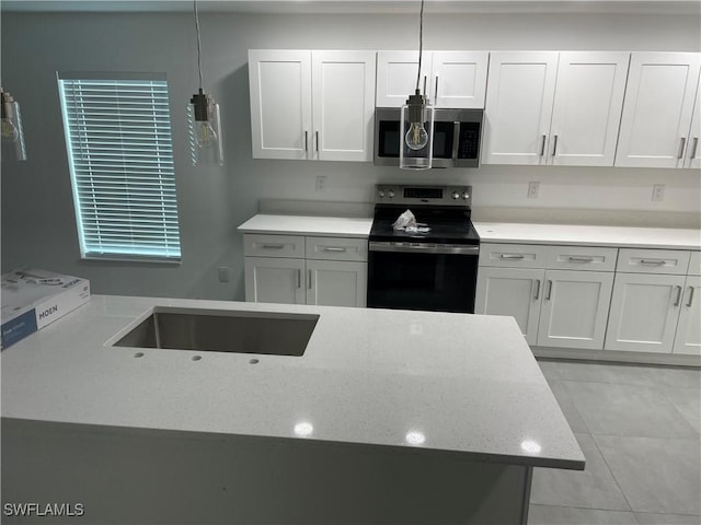 kitchen featuring electric stove and white cabinetry