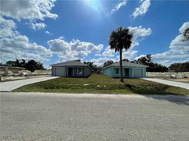 view of front of property featuring a garage and a front lawn