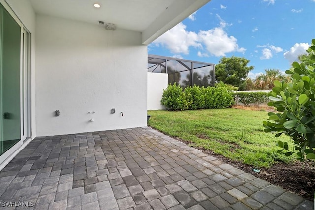 view of patio / terrace featuring a lanai