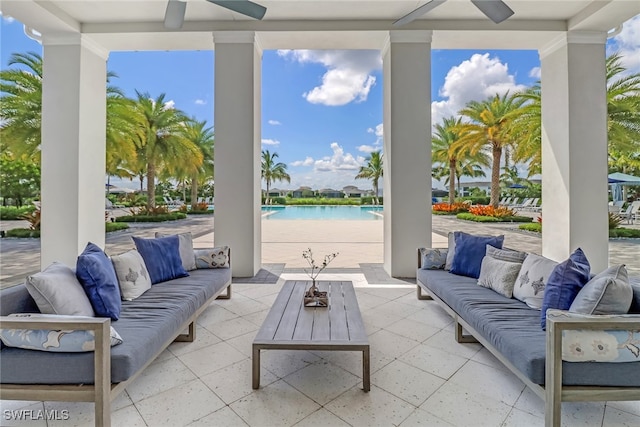 view of patio with ceiling fan, a water view, and an outdoor living space