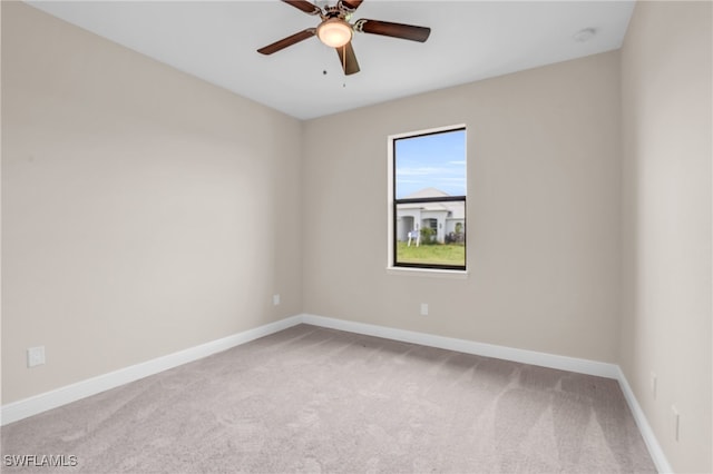 carpeted empty room featuring ceiling fan