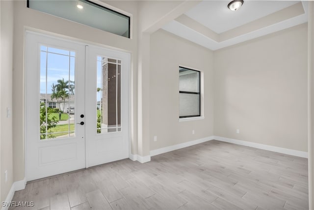 foyer entrance with french doors and light hardwood / wood-style flooring