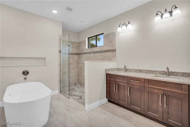 bathroom with separate shower and tub and vanity