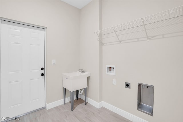 laundry room featuring electric dryer hookup, light hardwood / wood-style flooring, and washer hookup