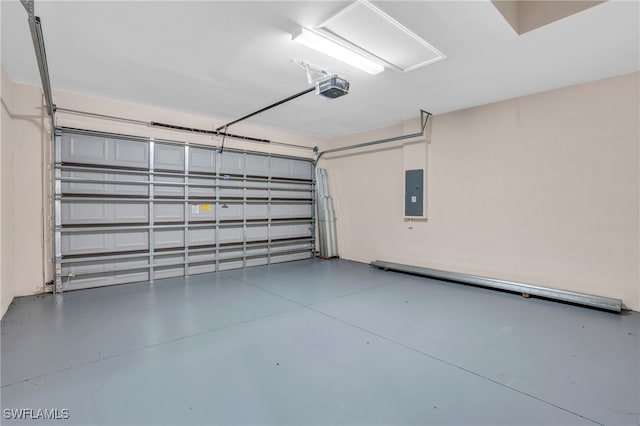 garage with a garage door opener and electric panel