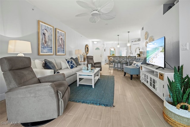 living room featuring ceiling fan and light hardwood / wood-style flooring