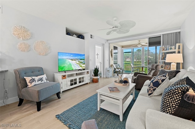 living room with ceiling fan and light wood-type flooring