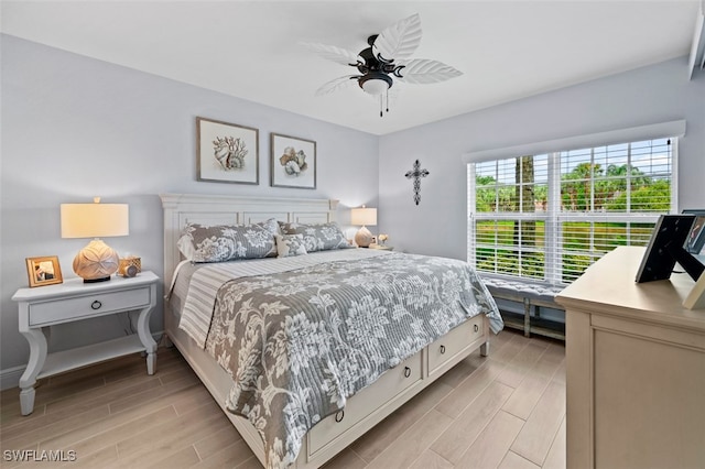 bedroom with ceiling fan and light wood-type flooring