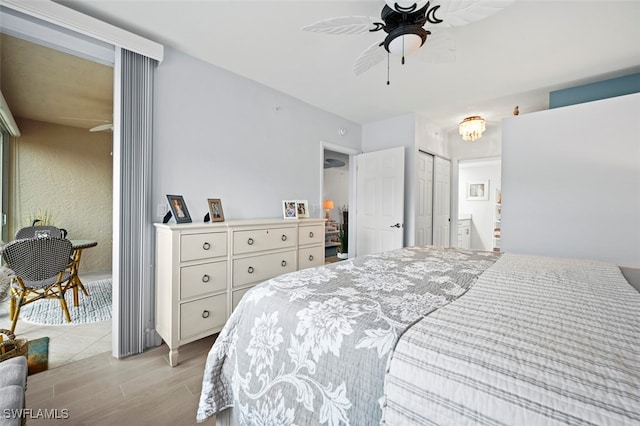 bedroom with ceiling fan, a closet, and ensuite bathroom