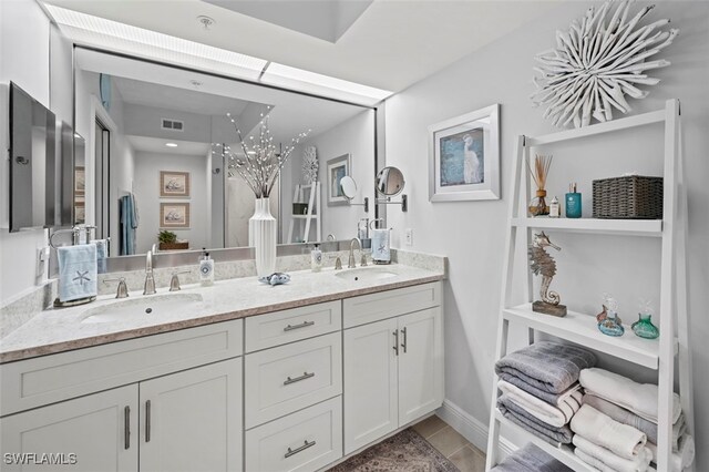 bathroom featuring tile patterned flooring and vanity