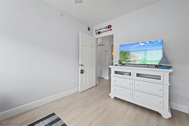 bedroom with ceiling fan and light hardwood / wood-style flooring