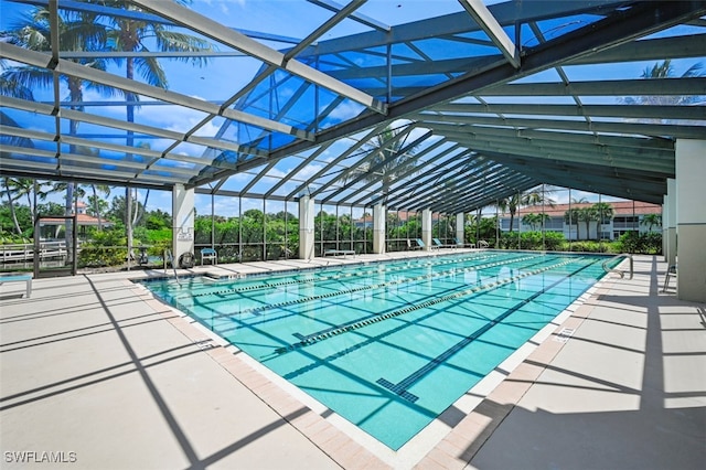 view of swimming pool with a patio area and a lanai