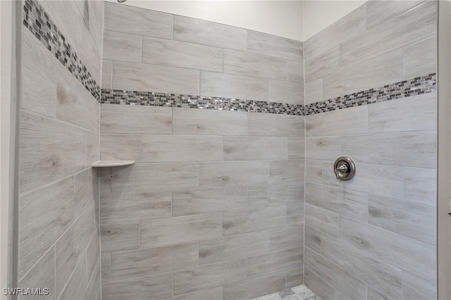 bathroom with tiled shower